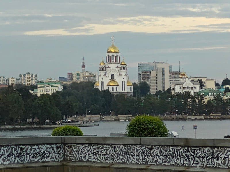 Храм-на-Крови и башни Екатеринбург-Сити за городским прудом, парапет в тегах